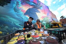 Field Street mural, lead artist Chuck Mayfield and assistant artist Cax One. Picture by Lachlan Bence