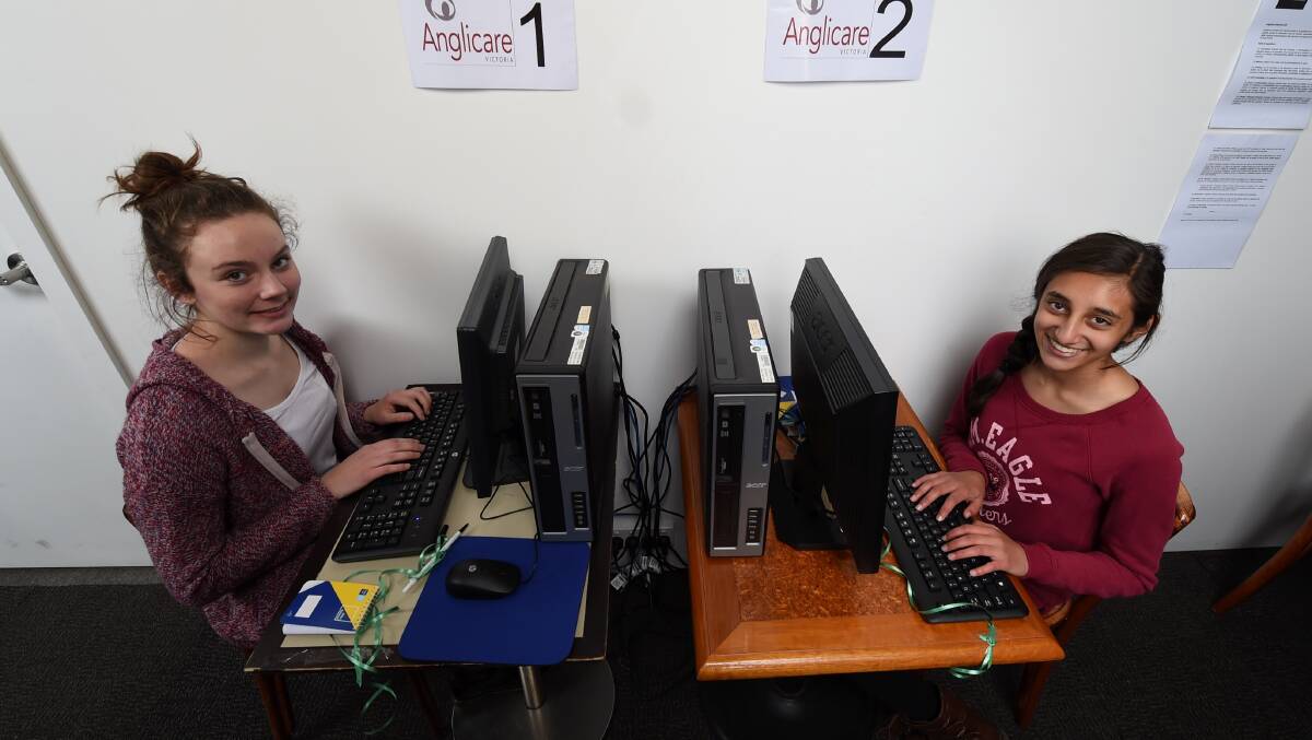 Anglicare Ballarat has set up an internet cafe to help those in need. Ballarat Grammar work experience students Aislinn A'Speculo and Evanee Verma test out the equipment. Picture: Lachlan Bence. 