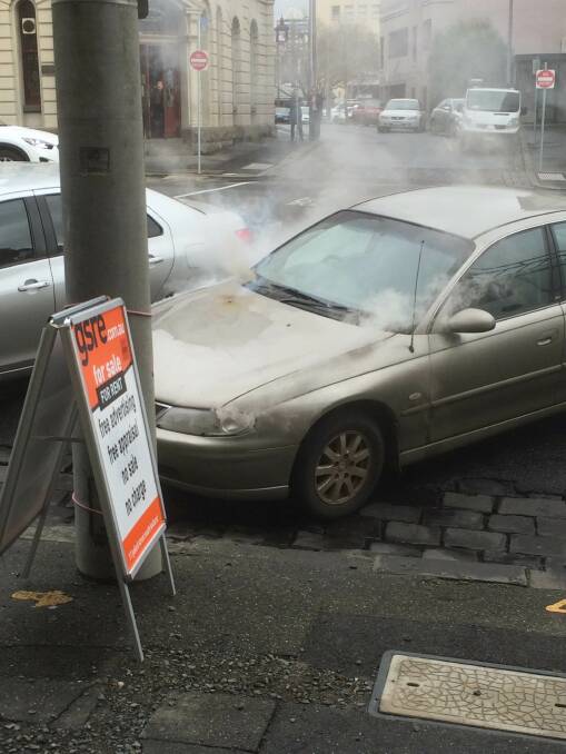 A car fire on Lydiard Street captured the attention CBD workers. Picture: Hayley Sandlant