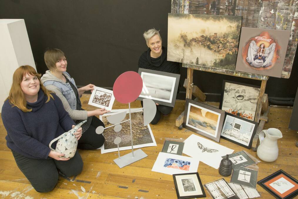 SHOWCASE: Wendy Poulter, Casey Bolton and Tas Wansbrough prepare for this week's fundraising arts auction. Picture: Supplied