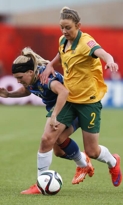 WORLD CLASS: Sweden's Elin Rubensson and Australia's Larissa Crummer struggle for the ball during the FIFA Women's World Cup match in June. 