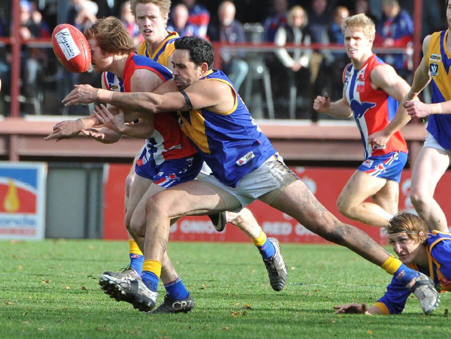 Nick Weightman (East Point) is tackled by Brett Goodes (Sebastopol).