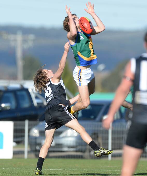 SPILLED IT: Lake Wendouree's Nathan Monk flies high but can't quite grasp the mark ahead of his former North Ballarat City teammate Josh Bromley-Lynch. Picture: Kate Healy.