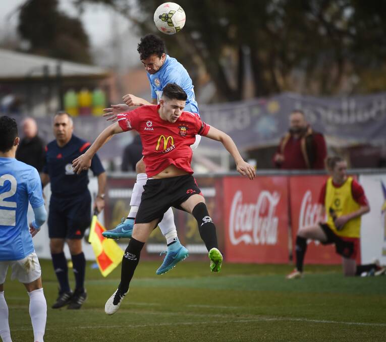 AERIAL BATTLE: Ballarat's Pat Karras and Melbourne City's Anthony Rizk clash in the air as they soar for the header.