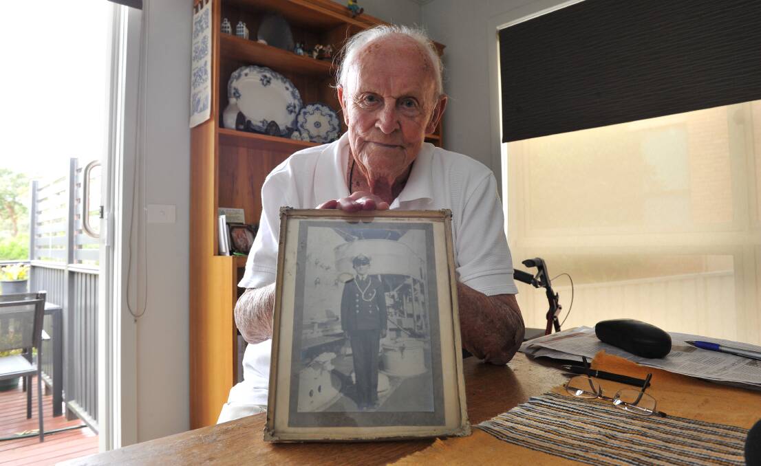 One of two: David Manning with a picture of himself in 1937 at the age of 13, as a naval cadet aboard HMAS Vampire. Mr Manning is one of two crew of the Perth still alive.  Picture: Lachlan Bence.