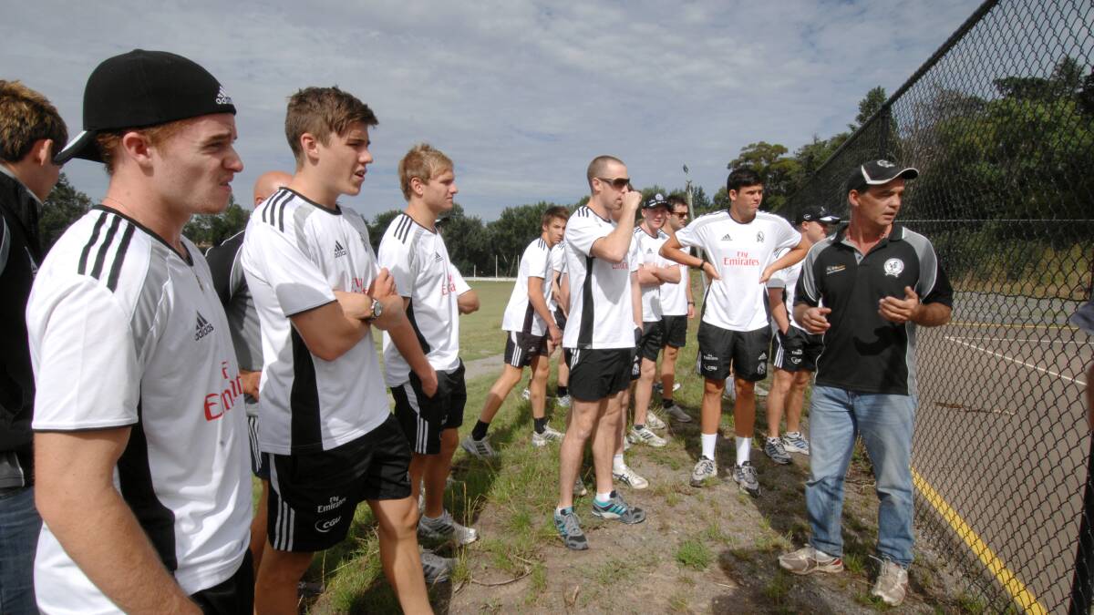 Garth leading Collingwood Football Club players on a tour of Clunes after the floods in 2011.