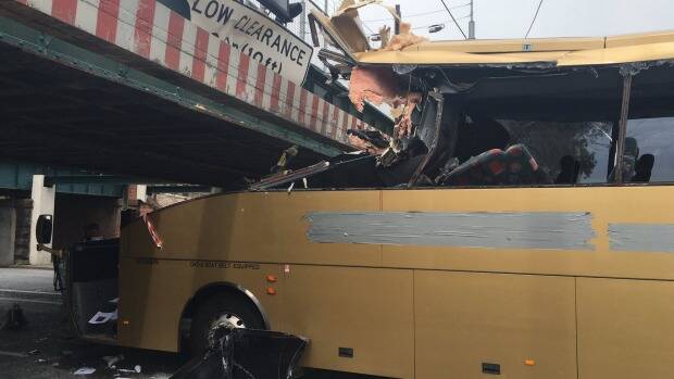 The Gold Bus logo was taped over after trapped passengers had been removed. Photo: Angus Ledwidge, Channel 9.