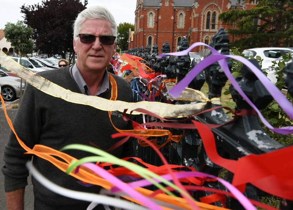 Survivor Phil Nagle has already been back out to put more ribbons on the fence today.
Photo: Lachlan Bence.