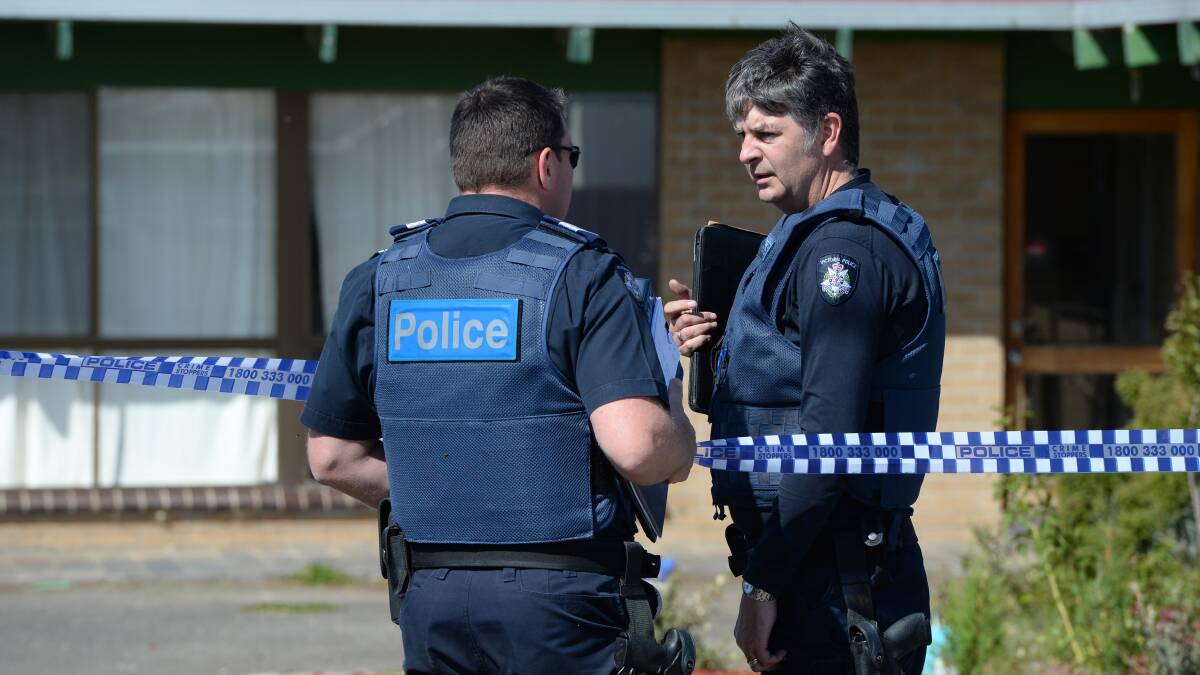 Senior Sergeant Neale Robinson and Leading Senior Constable Sean Clark at the crime scene. Picture: Kate Healy.