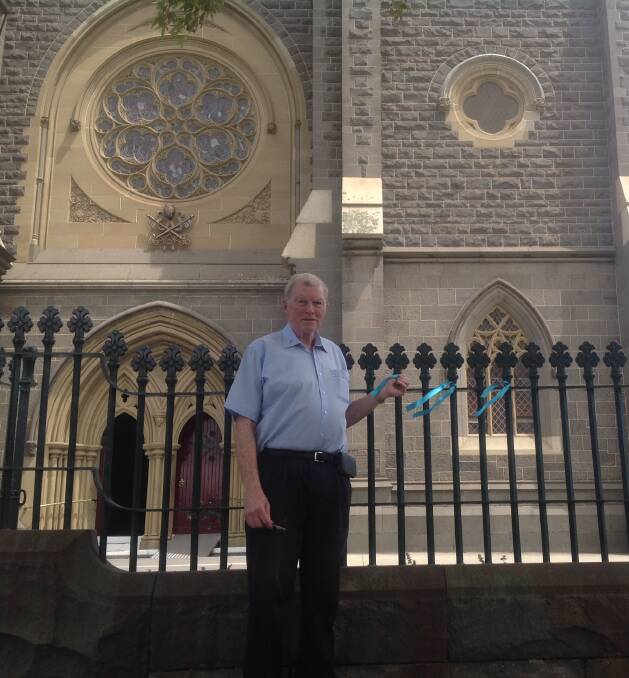 BREAKING THE SILENCE: Father Kevin Dillon tied a ribbon to the gates of St Mary's Basilica fence in Geelong in solidarity with clergy child sex abuse survivors.
