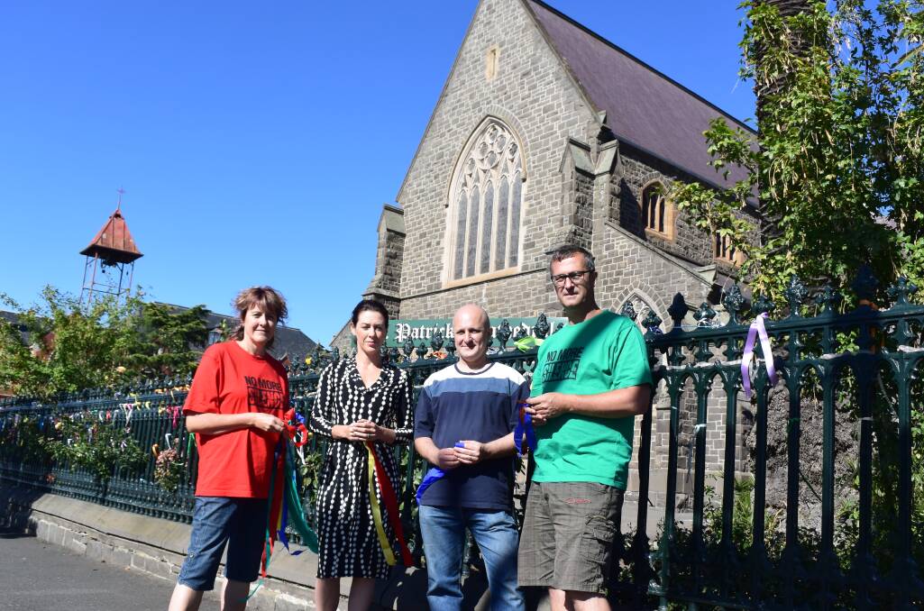 GETTING LOUDER: Loud Fence creator Maureen Hatcher with Gorgi Coghlan and survivors Andrew Collins and David Ridsdale outside the Loud Fence at St Patrick's Cathedral in Sturt Street.  