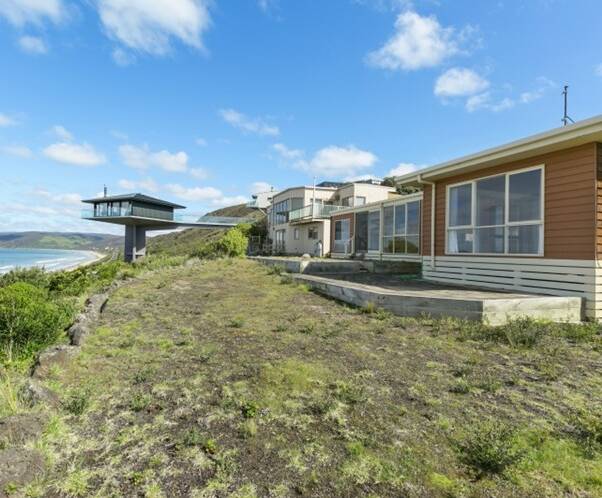 SOLD: The beach house owned by the former bishop Ronald Mulkearns at the exclusive Great Ocean Rd enclave of Fairhaven sold at an auction  for $2.1 million on Saturday.