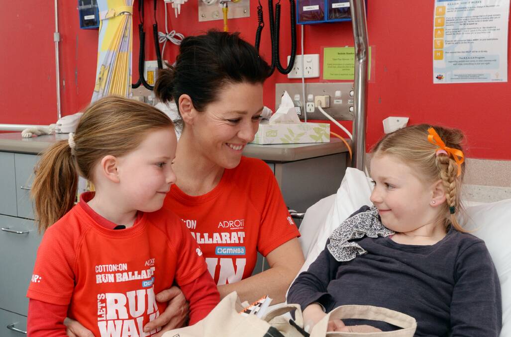 SUPPORT: Run Ballarat ambassador Gorgi Coghlan and her daughter Molly-Rose,5, meet Lacey Mannix, 5, at the children's ward on Monday. Picture: Kate Healy.