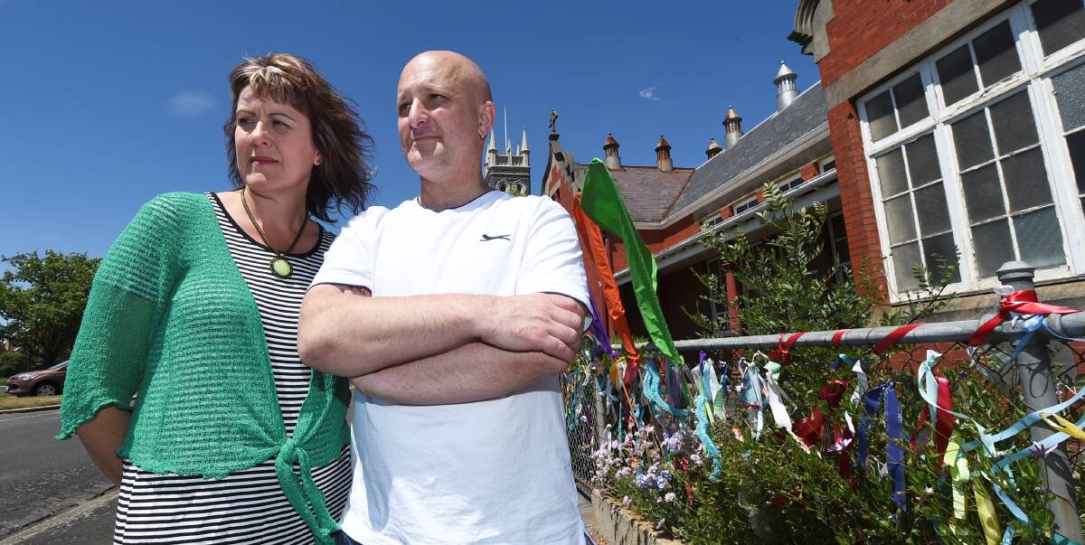 ONE YEAR ON: Ballarat's Loud Fence creator Maureen Hatcher and clergy sexual abuse survivor Andrew Collins outside the gates of the former St Alipius Boys' School.