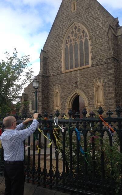SOLIDARITY: Ballarat Catholic Diocese Vicar-general Justin Driscoll tied a ribbon to the gates of St Patrick's Cathedral in support of clergy sexual abuse survivors. 