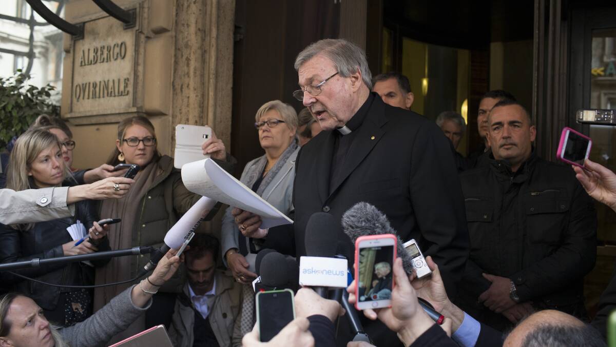 Cardinal George Pell reads a statement to reporters as he leaves the Quirinale hotel after meeting with survivors of sex abuse

