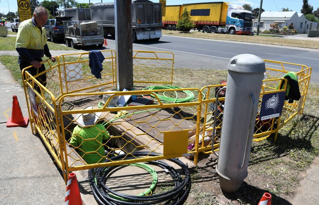 CONNECTED: Workers install the National Broadband Network in Albert Street, Sebastapol. NBN Co will connect 23,100 homes across the city. Picture: Lachlan Bence