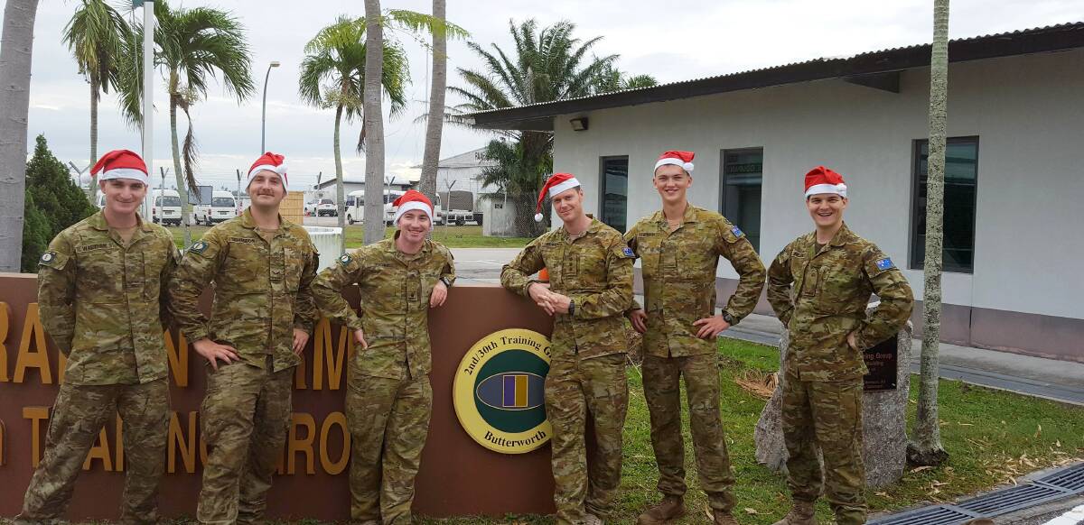 IN FOCUS: PTE Jonathan Walther, LCPL Darcy Demasson, MAJ Paul O'Donnell, CAPT Robert Powell, PTE Daniel Godson and PTE Brett Ireland in Malaysia.
