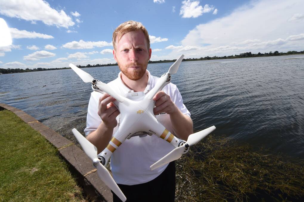 NOT HAPPY: Luke Parker with his drone, which he can no longer fly without a council permit. Mr Parker already has the highest level accreditation for flying drones with the Civil Aviation Safety Authority.