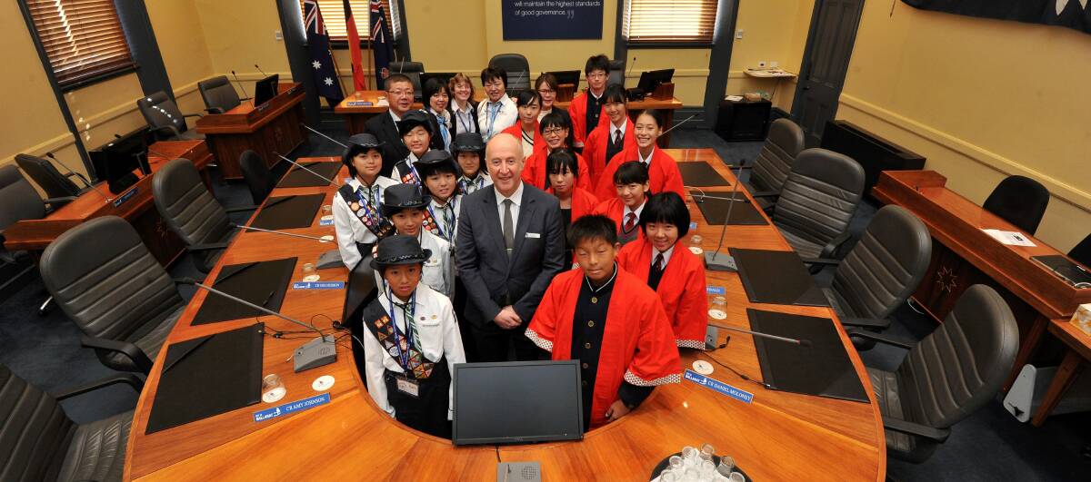 CULTURE SHOCK: Japanese students and girl scouts at Ballarat Town Hall with deputy mayor Mark Harris. Picture: Lachlan Bence