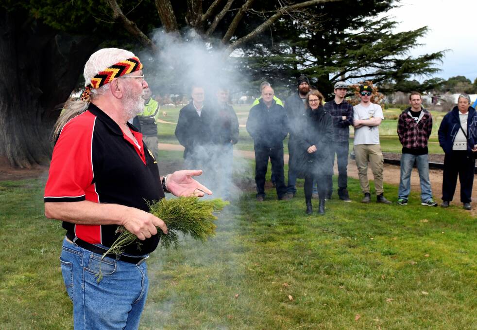Uncle Bryon Powell leads a traditional smoking ceremony at the Miners Rest Community Park. Picture: Lachlan Bence