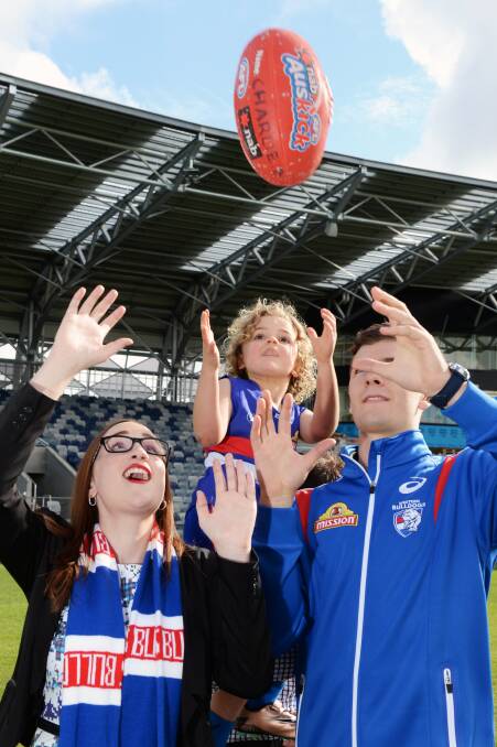 Charlie, 5, with Cr Amy Johnson and Western Bulldogs premiership player Josh Dunkley at Mars Stadium in July. Cr Johnson is also a Bulldogs supporter. Picture: Kate Healy