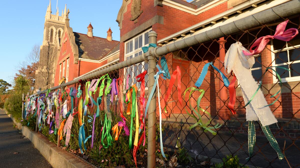 SUPPORT: Ribbons of support for victims and survivors of sexual abuse were tied to the fences of schools in Ballarat while the commission sat in the city during May. 