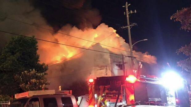 This photo from Twitter shows the flames engulfing the building in Oakland. Photo: AP/Twitter - @seungylee14