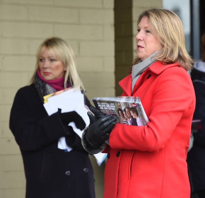 Cold outside: Sarah Wade and Catherine King at the Skipton Street early voting centre on Friday. PICTURE: Kate Healy 