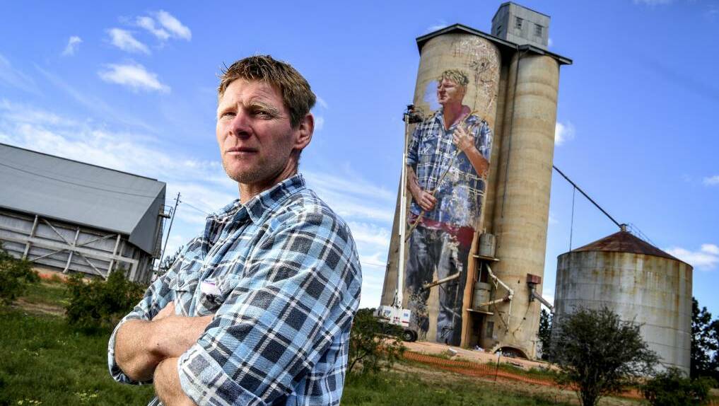 Local sheep and wheat farmer Nick Hulland, who is depicted on the disused silos at Patchewollock, in the Mallee. Photo: Eddie Jim