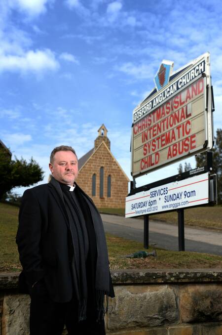 MORALITY MESSAGE: Father Rod Bower, in front of his famous roadside sign.