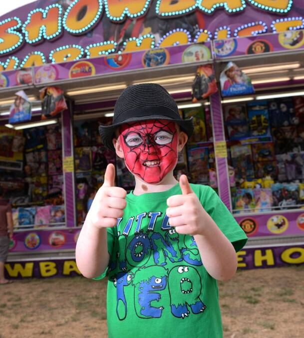 Thumbs up: Liam Riordan, resplendent in his Spiderman face paint, has fun at the Clunes Show sideshow and showbag stalls. 