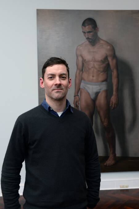 Artist Marcus Wills with his portrait of James Batchelor, The ersatz. Picture: Kate Healy