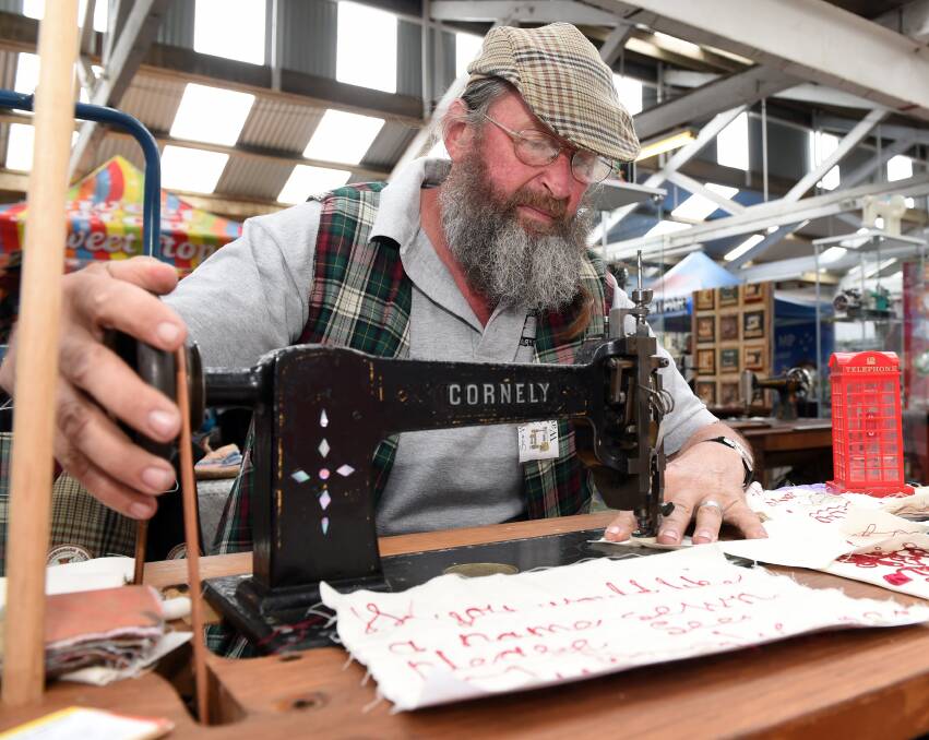 Spelling it out: Wayne McKail stitches with a machine from 1880, owned by Elsie Blick, who made Torvill and Dean's costumes when they visited in 1986.