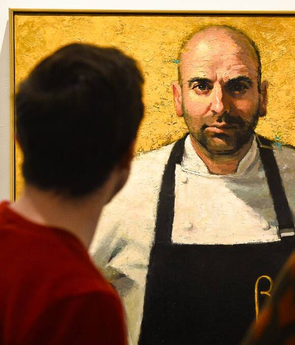 Master work: A gallery visitor takes a final look at Betina Fauvel-Ogden's portrait of George Calombaris, the winner of this year's Archibald Packing Room Prize. Picture: Dylan Burns