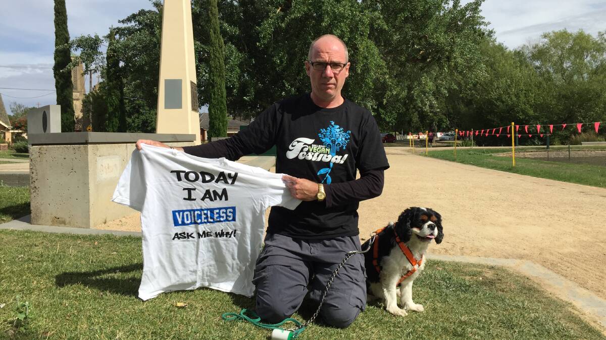 Solidarity: Ballarat Vegan Festival organiser Bryn Hills and his dog Charlie, who will go voiceless this Sunday to raise awareness of the plight of animals. Picture: Amber Wilson