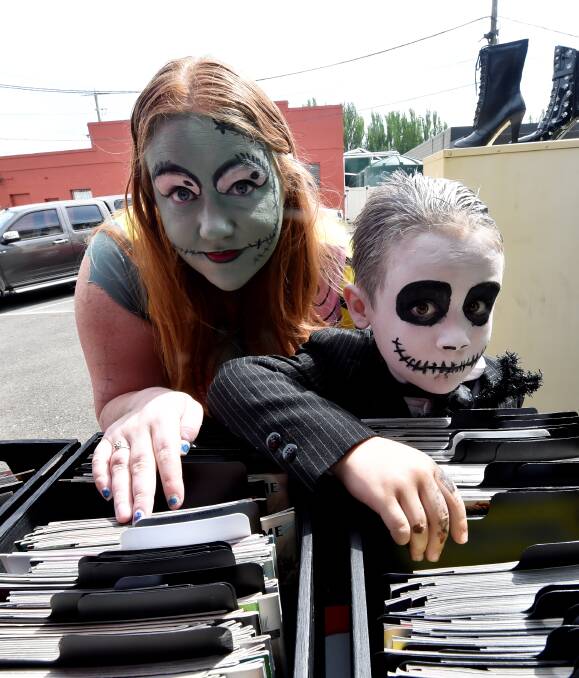 Files for your soul: Rhiannon Haynes and Des Habergger flick through creepy paraphernalia. This weekend and coming Monday promises to be the biggest Halloween the city has experienced yet.