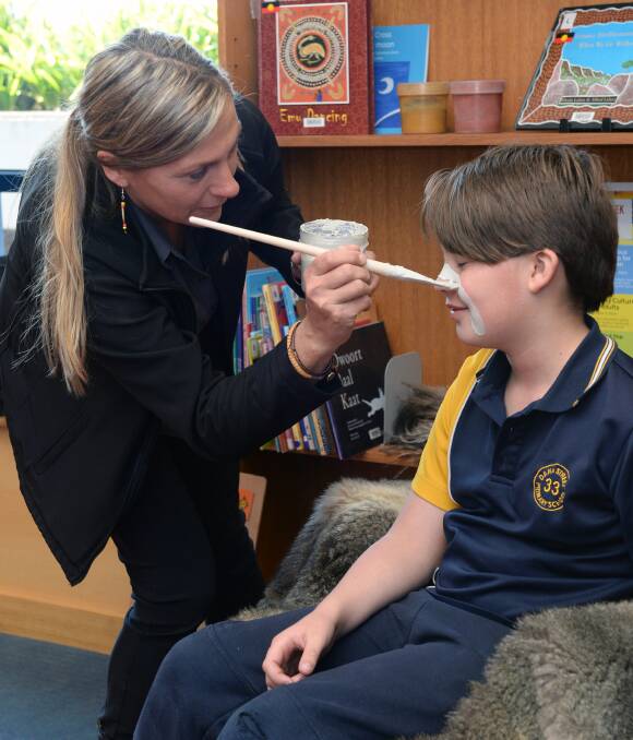 Indigenous tradition: Wadawurrung woman Tammy Gilson and Dana Street Primary School student Jack McKee, Grade 4, share in a face-painting tradition. Picture: Kate Healy