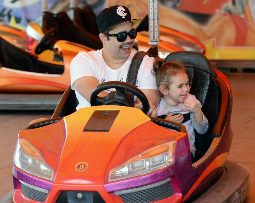 Dodgem dad: Anthony Pike and Morgan Pike, 4, from Delacombe, prove they've got the moves in a speedy orange number.
