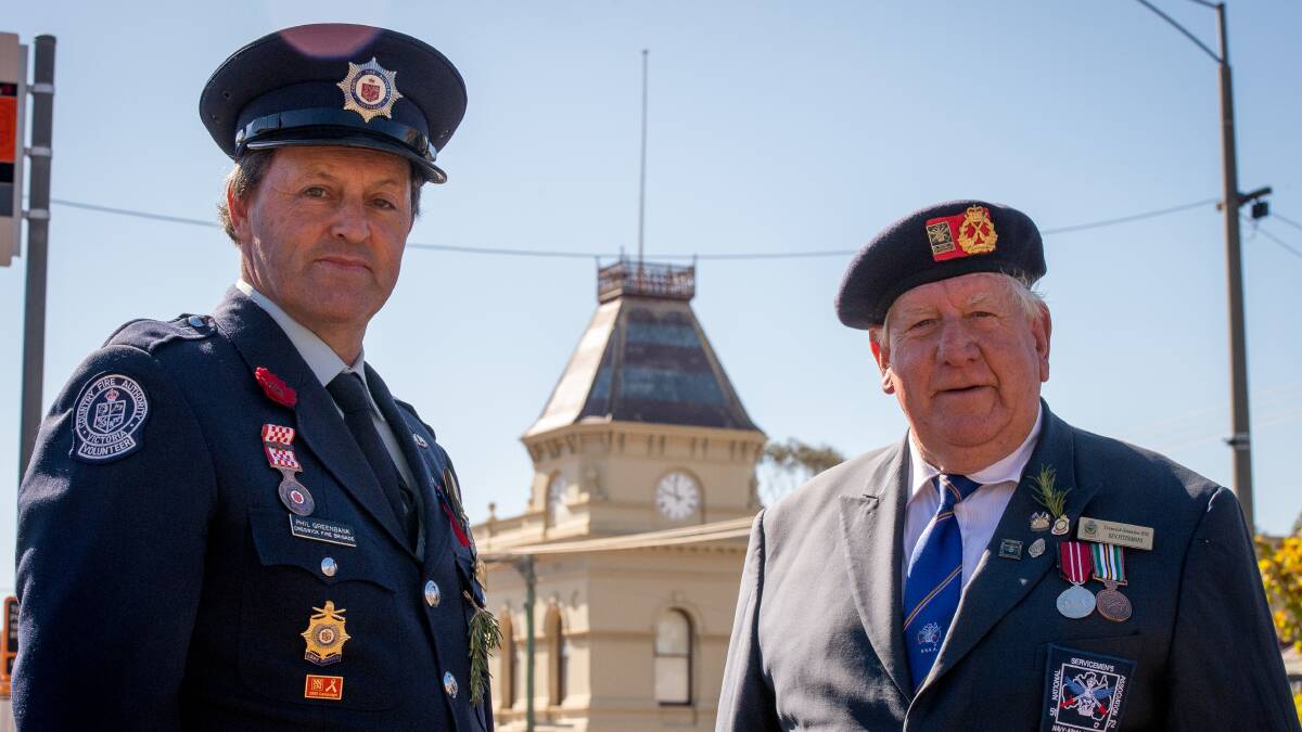 Flagless: Phil Greenbank from Creswick Fire Brigade and Ken Fitzsimons from Creswick-Smeaton RSL in front of Creswick's Town Hall, which is still sans the Australian and Aboriginal flags. Picture: Dylan Burns