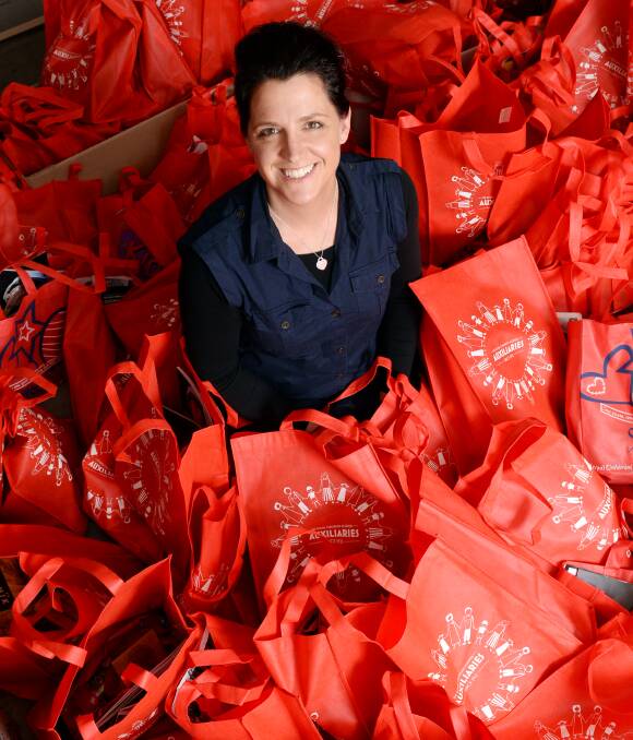 Tireless efforts: Alicia Jayne MacLean surrounded by showbags that will be given to guests on the night of the Making a Difference Gala Ball. Paralympian Kelly Cartwright will speak at the event. Picture: Kate Healy