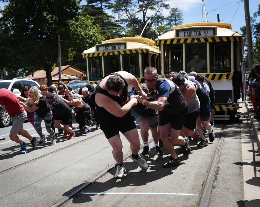 Muscle against metal: Perfit Health and Fitness (left) and CB Training use brute strength to pull the heavy loads along Wendouree Parade. Picture: Luka Kauzlaric