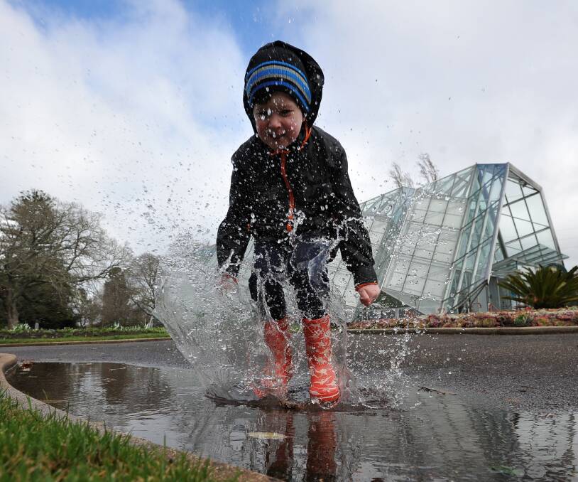 SPLISH, SLASH: Darcy McLaughlin, 5, enjoys some puddle jumping at the Ballarat Botanikids winter event at the Botanical Gardens. Picture: Lachlan Bence