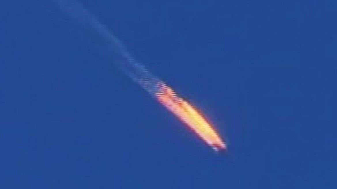 SHOT DOWN: A Russian warplane is on fire before it crashes on a hill as seen from Hatay province, Turkey. 
