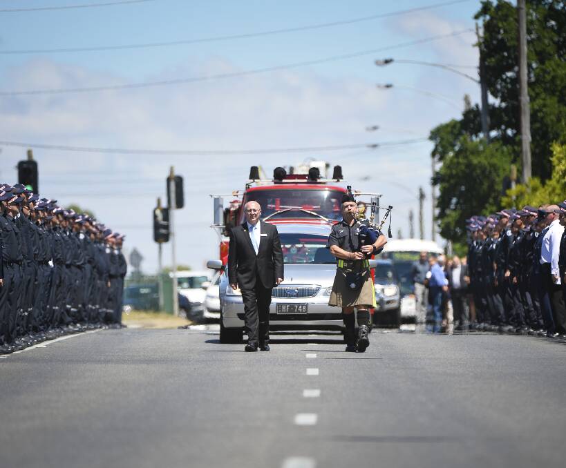 RESPECT: A guard of honour is formed by firemen and soldiers in Howitt Street on Friday to farewell Nathan Shanahan. Picture: Dylan Burns