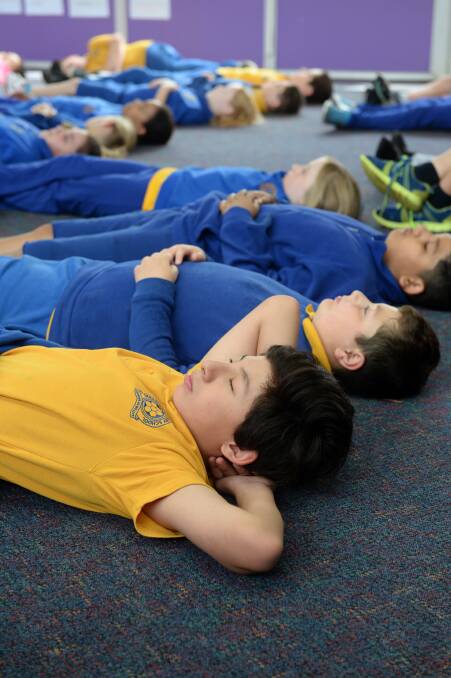 IN THE MOMENT: Sebastopol Primary School pupils, including Rhonan front, practices mindfulness via the Smiling Minds app. Picture: Kate Healy