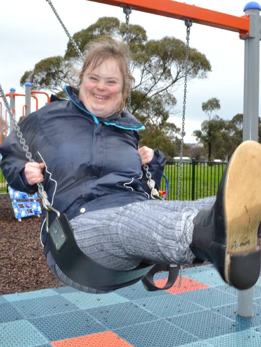 ALL SMILES: Anna, from Pinarc Independent Living Services, tries out the upgraded and inclusive Pennyweight Park playground. Picture: Glen Crompton