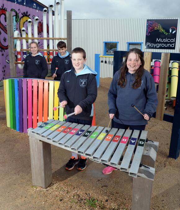 COLOUR CODED: Enjoying the Miners Rest Primary School musical playground are, from left, Sophie Drabsch, Riley Hedger, Liam King and Emma Bennett. Picture: Kate Healy