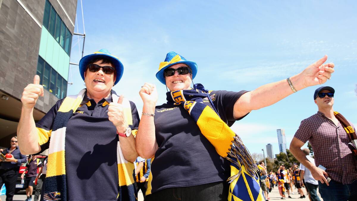 Fans proudly supporting their teams at the 2015 AFL Grand Final.