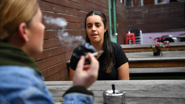 Bryony Fitzgerald, manager of The Last Jar, with a smoker in the beer garden. Photo: Joe Armao

